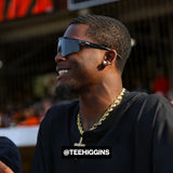 Tee Higgins in all-black outfit and black LosReyes sunglasses with gold chain.