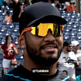 Tua Tagovailoa in Peach LOSREYES sports sunglasses with black cap.