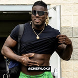 Lifestyle shot of NFL athlete Chief Njoku wearing LosReyes black mirrored wraparound athletic sunglasses post-workout, flexing in streetwear style for an outdoor fit check