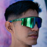 Lifestyle front view of LosReyes Prime Galaxy Earth sunglasses worn outdoors, showcasing green-blue mirrored wraparound lens and ultra-light sport design for versatile, stylish UV protection.
