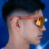 Lifestyle side profile of LosReyes Prime Galaxy Mars wraparound sunglasses showing deep amber reflective lens, durable side arms, and sporty profile for everyday athletics.