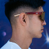 Side lifestyle shot of LosReyes Prime Galaxy Pluto mirrored shield sunglasses on athlete, highlighting ergonomic red frame and sleek UV shield lens.