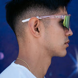 Side profile of LosReyes Prime Galaxy Venus sunglasses on model, featuring pink mirrored lens and translucent frame with white temple arms for secure fit.