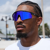 Side profile of a focused basketball athlete in electric blue LosReyes Prime Polarized sunglasses – futuristic performance eyewear engineered for speed, style, and sport