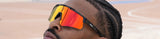 Close-up of athlete relaxing on basketball court, wearing black uv protection LosReyes cool sports premium glasses with wide orange mirrored shield lenses, polarized basketball eyewear