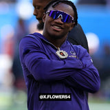 Lifestyle photo of NFL wide receiver Zay Flowers wearing LosReyes purple mirrored shield sports sunglasses featuring wraparound performance design, UV400 protection, and bold athletic style on the sideline.