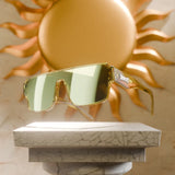 Apollon polarized acetate-frame sunglasses with anti-scratch, sweat-resistant lenses displayed in front of a golden sun sculpture.