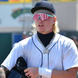 Max Clark wearing Flying Tigers jersey and LosReyes sunglasses with pink lenses and teal frame during a baseball game.