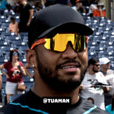 Tua Tagovailoa in Peach LOSREYES sports sunglasses with black cap. 