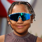 Child wearing Candy Collection Cream Blue kids sport sunglasses with blue mirrored lens