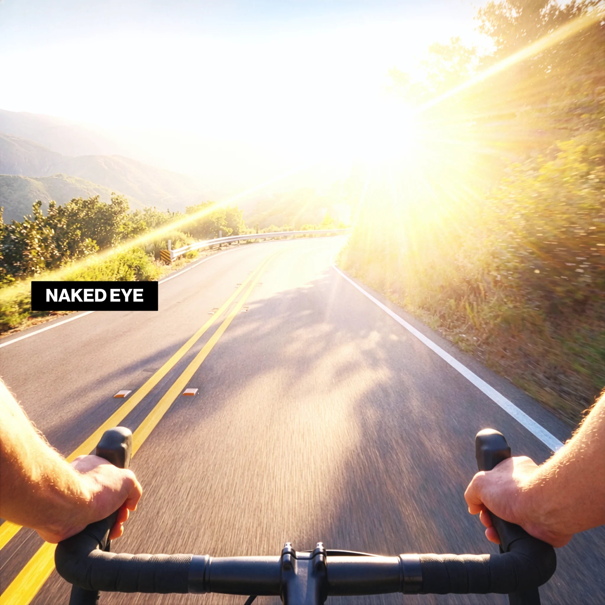 First-person view of a cyclist riding on a winding mountain road with intense sun glare and blown highlights, captured with the naked eye.