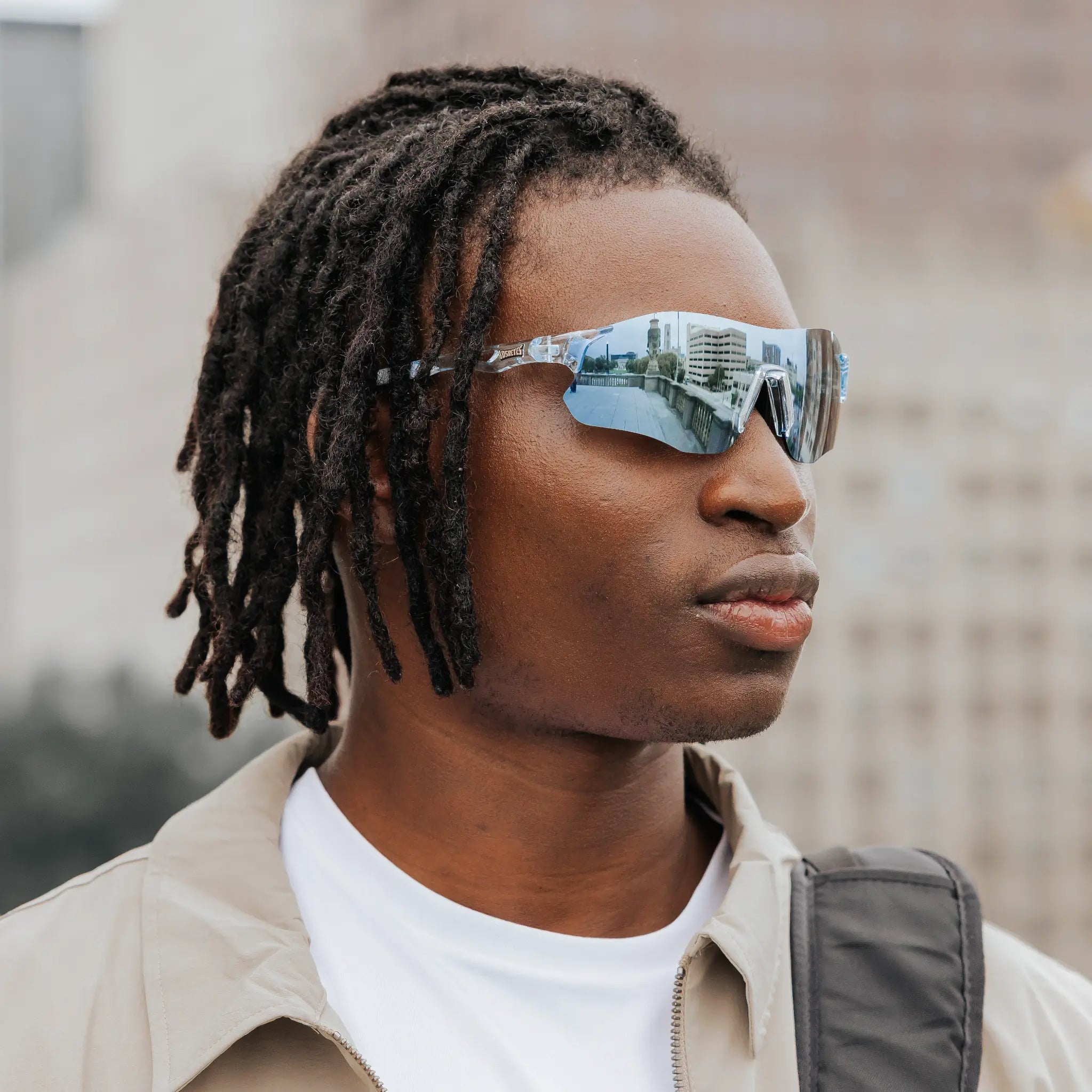 Angled close-up of Edge Ocean sunglasses showing wraparound design and blue mirrored lenses.