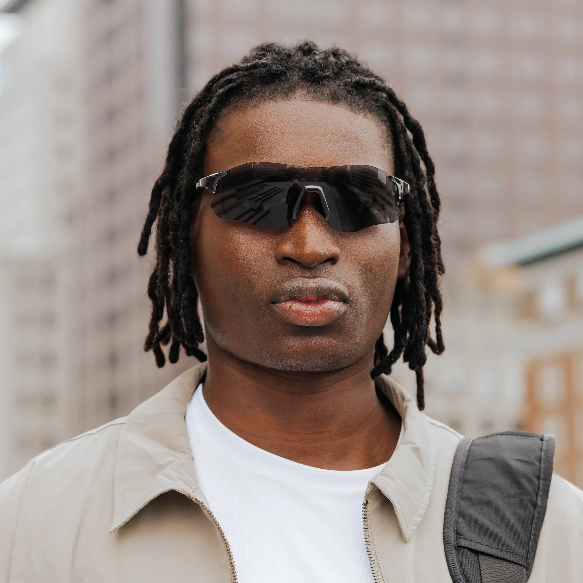 Front view of model wearing Edge Shadow sunglasses with dark shield lenses.