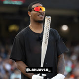 NFL player Ja'Marr Chase wearing LosReyes polarized red sports sunglasses with mirrored lenses during a baseball event, smiling and holding a water bottle, showcasing high-performance athletic eyewear.