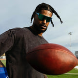 Ross500 in LosReyes  Blue Raz Elevate Collection sunglasses, engineered for speed and clarity with polarized glare reduction and seawater-resistant coating during football action.