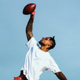 Ross500 in pink LosReyes Bubble Gum Elevate sunglasses during football drills, showing durable TR90 frames and full UV400 protection