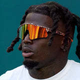 Close-up of man in LosReyes Cheetah Orange mirrored sunglasses with patterned frame – bold designer wraparound sports sunglasses for men.