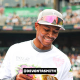 Lifestyle shot of Devonta Smith wearing LosReyes pink wraparound sports sunglasses featuring mirrored shield lenses, athletic frame design, and UV400 protection — perfect for performance and celebrity street style.