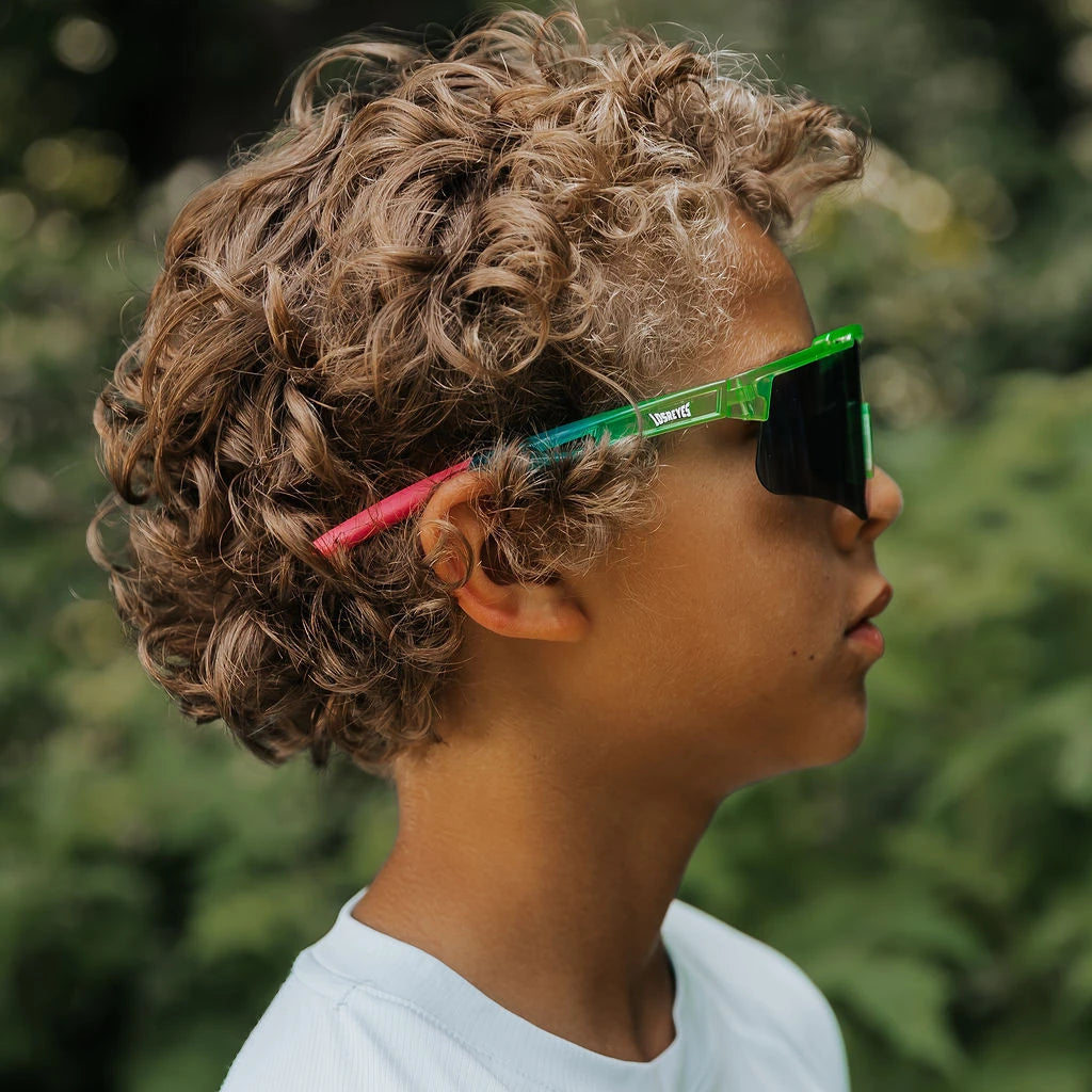 Youth wearing LosReyes Jurassic Series Pterodactyl green sunglasses outdoors