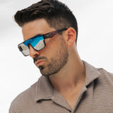 Man wearing futuristic sunglasses with a neutral background from Losreyes Hades pair from Omega collection