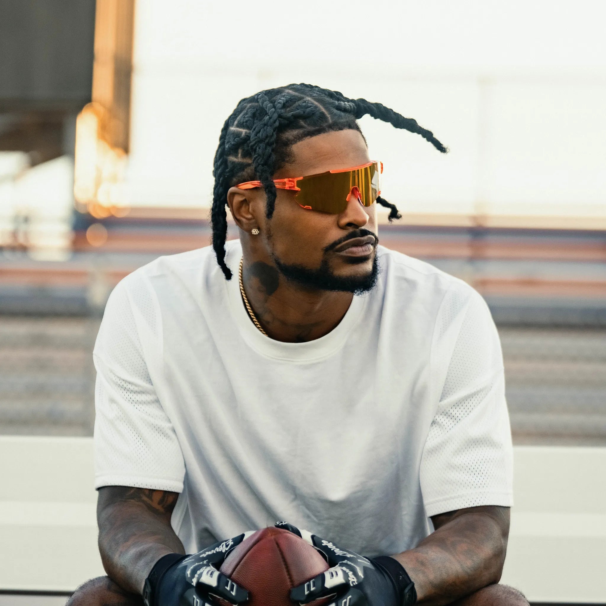 LosReyes Peach Elevate sunglasses worn by Ross500 while playing football, orange mirrored shield lens built for style and speed.