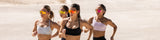 Group of athletes wearing LosReyes performance sunglasses while running together outdoors, featuring mirrored lenses designed for speed and glare reduction