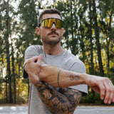 Athlete stretching in the woods wearing LosReyes Polarized Yellow sunglasses, engineered with glare-cutting polarized lenses and lightweight TR90 frames for serious outdoor training.