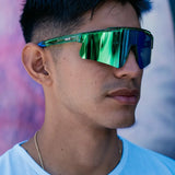 Lifestyle front view of LosReyes Prime Galaxy Earth sunglasses worn outdoors, showcasing green-blue mirrored wraparound lens and ultra-light sport design for versatile, stylish UV protection.