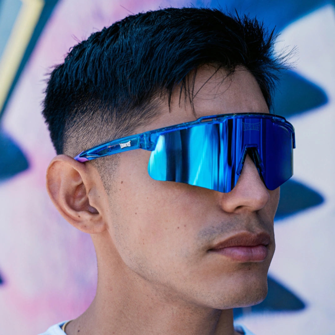 Lifestyle photo of LosReyes Prime Galaxy Neptune mirrored blue sunglasses worn by athlete outdoors, emphasizing modern performance design and UV defense