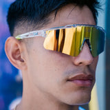 Lifestyle close-up of LosReyes Prime Galaxy Saturn mirrored sports sunglasses on model, showing full shield coverage and high-performance wrap for training or competition.