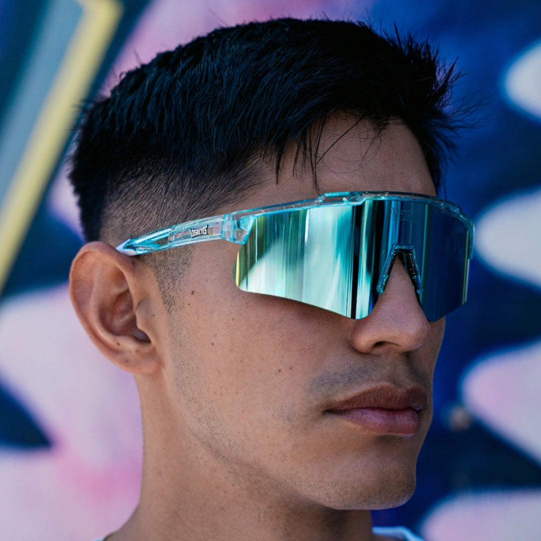 Close-up of LosReyes Prime Galaxy Uranus mirrored sports sunglasses on model, with curved blue shield lens and clear frame delivering elite protection and athletic edge.