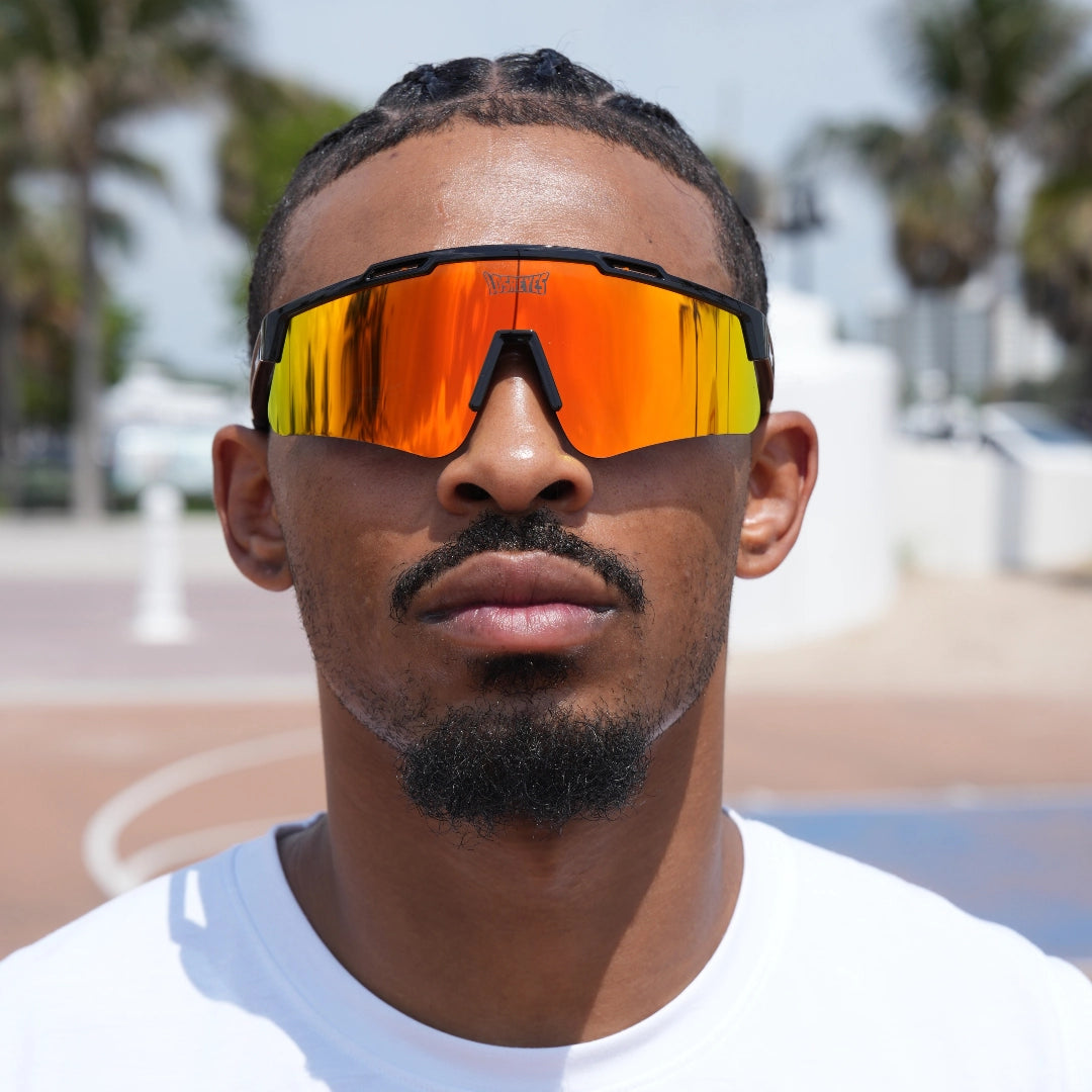 Hooper showcasing fiery orange LosReyes Prime Polarized sunglasses – ultimate performance eyewear for basketball training sessions