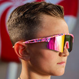 Side profile of boy wearing LosReyes Prime Youth Cream performance sunglasses with UV400 mirrored lenses and colorful sprinkle-print frame, ideal for active youth lifestyle