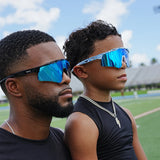 Father and son wearing LosReyes blue mirrored sports sunglasses on a football field