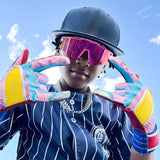 Kid athlete wearing pink-mirror LosReyes candy cream sunglasses and colorful batting gloves