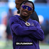 Lifestyle photo of NFL wide receiver Zay Flowers wearing LosReyes purple mirrored shield sports sunglasses featuring wraparound performance design, UV400 protection, and bold athletic style on the sideline.