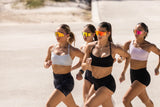 Four women running outdoors on a sunny day wearing losreyes sunglasses bought on early black Friday sale 40% off 